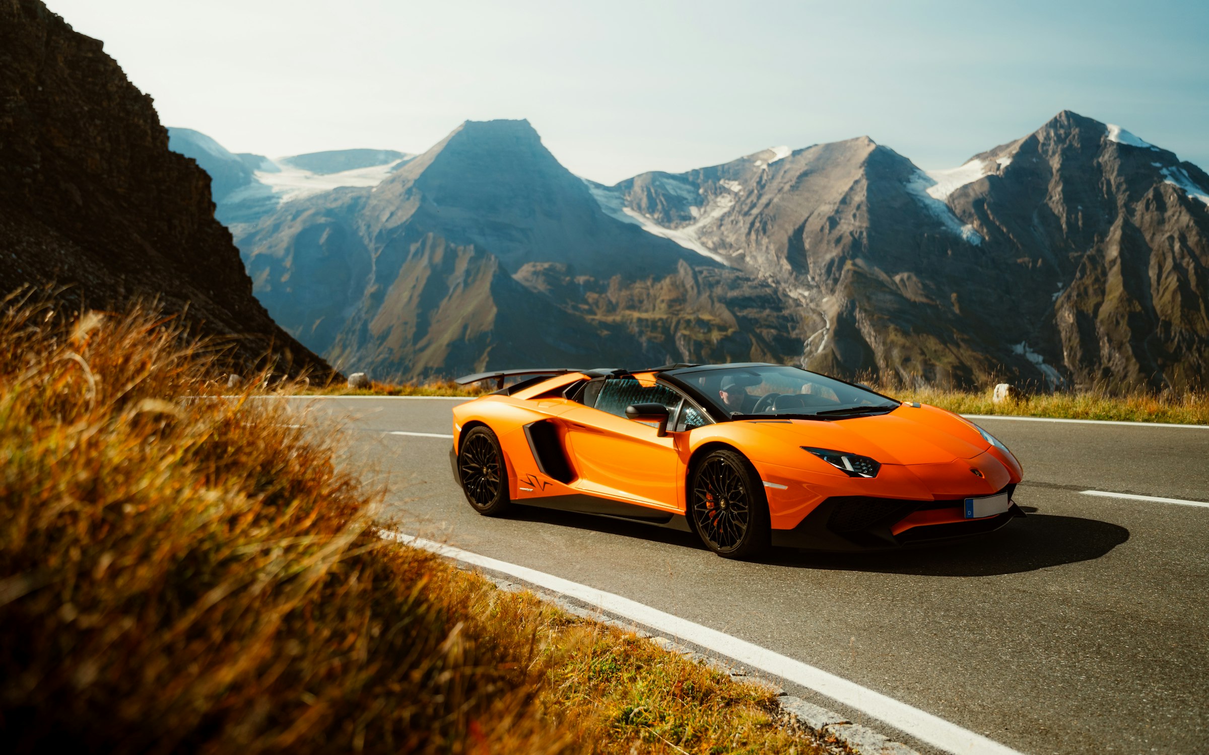 Orange Lamborghini on a mountain road